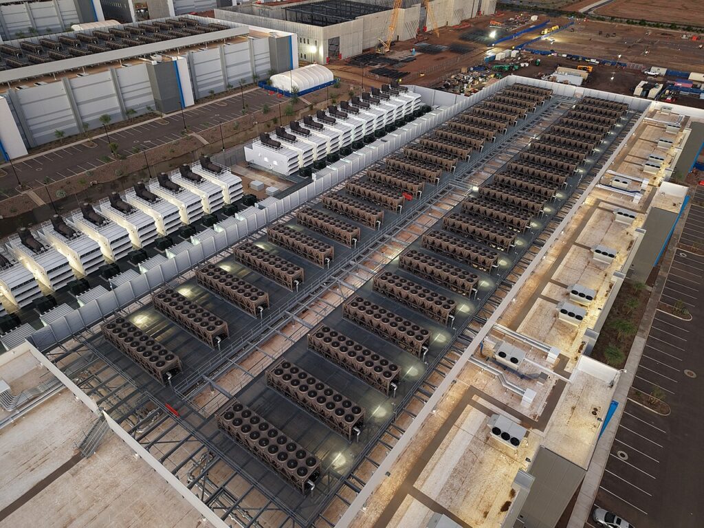 Aerial view of a large data center roof with extensive cooling and power infrastructure