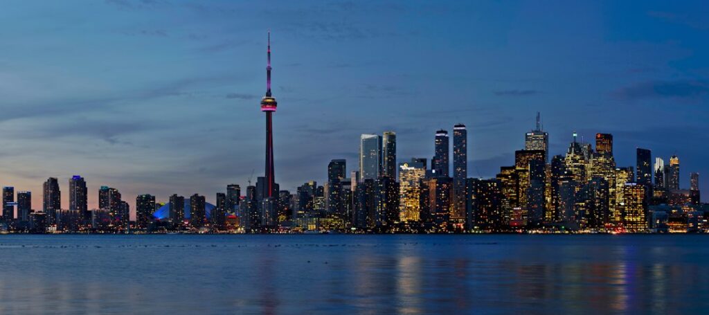 Toronto skyline illustrating Canada's rising household wealth and continuing affordability pressures. Photo by Jochem Raat on Unsplash.