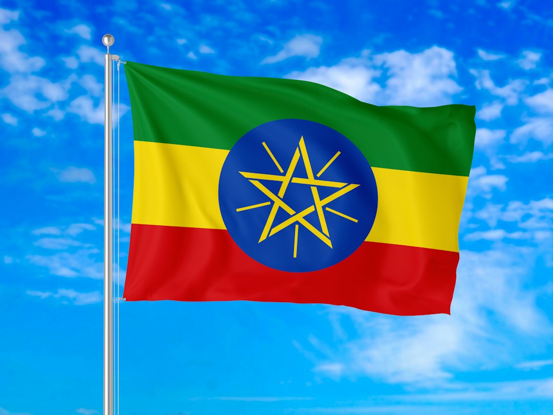 Ethiopia’s green, yellow and red national flag flying against a bright blue sky, representing the renewed conflict in northern Ethiopia.