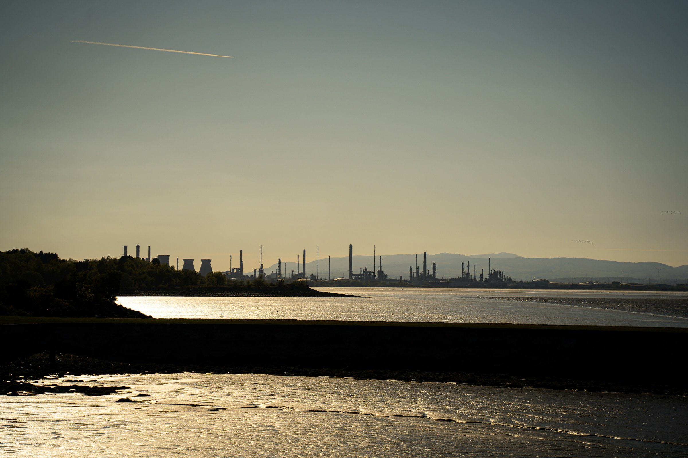 Dramatic oil refinery skyline at sunset illustrating Middle East energy and supply risks